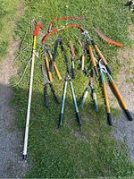 All assorted pruning tools laid on grass showing inventory and wear