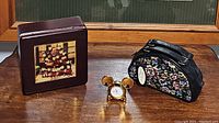 Photo showing the three items: wooden box with vintage Mickey Mouse image and small doll, gold-tone Mickey ears watch, and floral tapestry purse with handle for Mary Poppins 30th anniversary music watch.