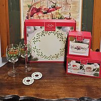 Full lot includes two holly berry wine goblets, Lenox dessert server in box, winter greetings bowl box, and two boxed holiday mugs.