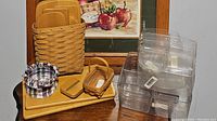 Full view showing tall basket holding wooden trays, small basket, plaid fabric liners, plastic protectors to the side.