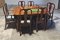 Full view of maple dining table with six chairs