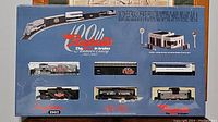 Top view of the boxed train set showing locomotive and multiple railcars with Raybestos branding and 100th anniversary logos from 1902 to 2002.