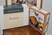 Boxed Williams-Sonoma roaster and Dixie Chicken cooker side by side