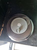 Top view of GE rotating CD cleaner showing transparent circular body with central grey control knob and handle