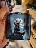 Photo of one dark blue bottle of Oxford Bleu cologne by English Laundry with silver cap and logo