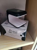 Mini LED lamp placed on top of its box, showing the product and packaging with brand GelMoment and product name Mini LED Lamp.