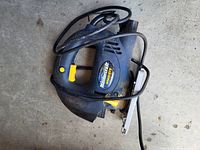 Mastercraft Voltage electric jigsaw with power cord, lying on concrete floor