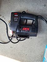 Black Skil 4225 electric jigsaw with visible model number and electrical specifications on side label. Power cord attached, no visible damage.