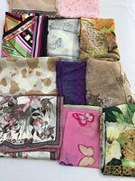 Lot of ten colorful preowned silk scarves arranged in a grid pattern showing various designs such as geometric, floral, animal print, and butterfly motifs.