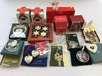 Overview of entire lot including boxed and loose Christmas ornaments with various designs and brands