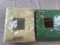 North Shore Linens 2 Pack Fleece Throw Set in original packaging alongside Cozelle 100% cotton throw in green packaging.
