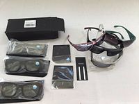 Overview photo showing all nine eyewear items: three sealed reading glasses and six sunglasses with various frames and lenses arranged on a white surface.
