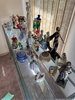 Wide shot of entire grouping of porcelain and glass items on table