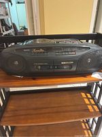 Full view of Sanyo portable boombox featuring CD player on top, cassette player, built-in speakers, and integrated handle.