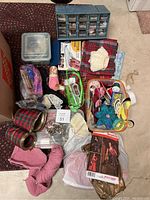 Overview shot of all crafting and sewing supplies including boxes, ribbons, yarn, lace, and fabric pieces.