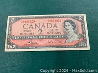 Front side of the 1954 Canadian two dollar bill showing Queen Elizabeth II portrait and serial number.