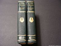 Photo of the spines of two leather bound Mark Twain books: 'Pudd'nhead Wilson' and 'A Connecticut Yankee, Etc.', showing gold embossed titles and publisher name Collier.