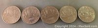 Front view of five Canadian $5 coins from 1978, 1979, 1980, 1981, and 1986 with canoe designs