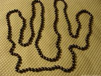 Full-length view of necklace laid out showing entire 62-inch strand.