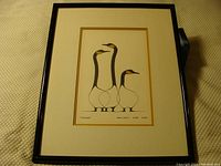 Front view of the framed print depicting three stylized birds.