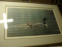 Framed numbered print showing two loons swimming on calm water surface.