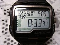 Close-up photo of Timex Expedition digital watch screen showing time, date, and various function indicators.