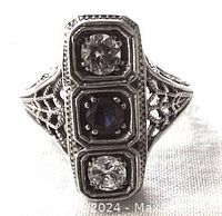 Front view of the sterling silver Art Deco style ring showing the three stones and detailed filigree work on the top and sides.