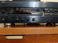 Front view of Yamaha RX-396 stereo receiver showing digital display and control knobs.