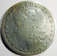 Obverse side of 1899-S Morgan silver dollar showing Lady Liberty profile with date and inscriptions.