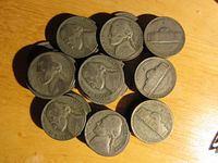 Top and side views of multiple circulated War Time nickels showing worn obverse and reverse sides with date and mint marks partially visible.