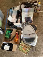 Full lot showing ceramic air heater, shoulder therapy wrap, LED daylight lamp, small fountain pump, solar device, and power cords.