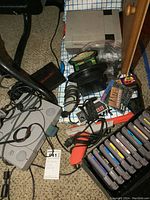 NES and PS1 consoles with controllers, light guns, multi-game adapter and cartridge case