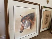 Framed print showing two horses, adult and foal, in a side profile. The print is signed and numbered by Fred Stone.