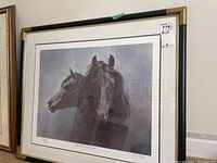 Front view of framed print showing the artwork of two black horses, title and signature, and numbered edition.