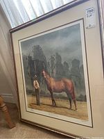 Full frontal view of framed print showing horse and handler scene