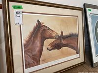 Full view of the framed horse print showing two brown horses against a beige background, signed and numbered, with mat and gold-tone frame.