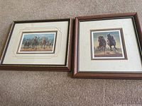 Two framed horse racing prints by Fred Stone, laid on carpet. One with two jockeys on horses, the other with a group of horses racing.