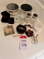 Photo showing entire lot including crystal jars, perfume bottles, wallet, scissors, clips, and jewelry boxes