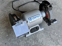 Full view of Craftex 6" bench grinder showing grinding wheels and protective shields (one missing).