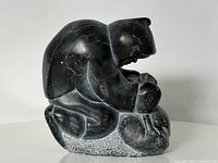 Front right three-quarter view showing kneeling figure and tools