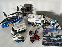 Overview of all LEGO vehicles and sets including the Police Mobile Command Center, Chinook Helicopter, armored truck, street sweeper, crooks' hideout, getaway cars, and minifigures
