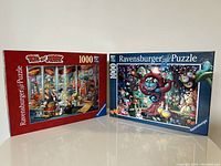 Both puzzle boxes shown side by side, depicting the Tom and Jerry and Alice in Wonderland puzzle images on the fronts.