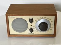 Front view of radio showing speaker grille, knobs, tuning dial and faceplate