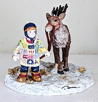 Full view of the Enesco Trisha Romance figurine showing child with reindeer on snowy base