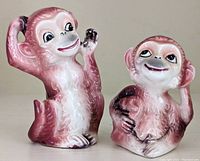 Front view of the two ceramic monkey salt and pepper shakers showing detailed faces and poses