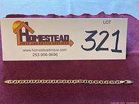 Full view of bracelet beneath lot sign