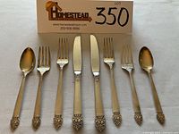 Overhead view of all eight flatware pieces arranged in a row.