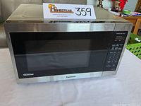 Front view of Panasonic inverter microwave oven with stainless steel finish and digital control panel.