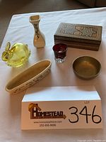 Photo showing full assortment from above: Weller pottery dish, yellow glass bunny, Angeles California vase, inlaid wooden box, brass bowl, glass cup