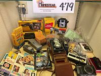 Full assortment of cameras and accessories on shelf